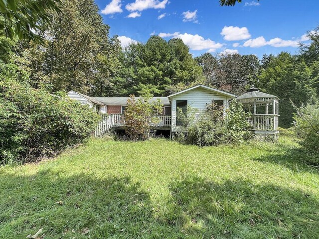 view of yard with a wooden deck and a gazebo