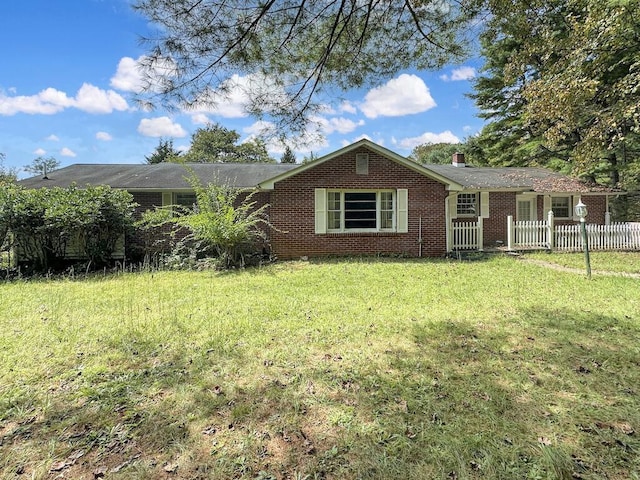 53 Woodberry Ln, Galax, VA 24333 - view of front facade featuring a chimney, fence, a front lawn, and brick siding