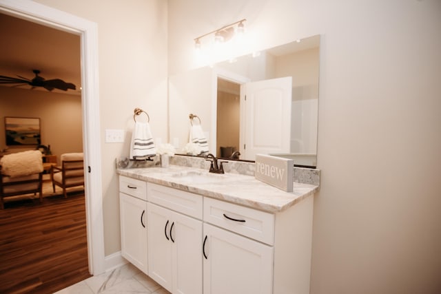 bathroom with ceiling fan, vanity, and hardwood / wood-style floors