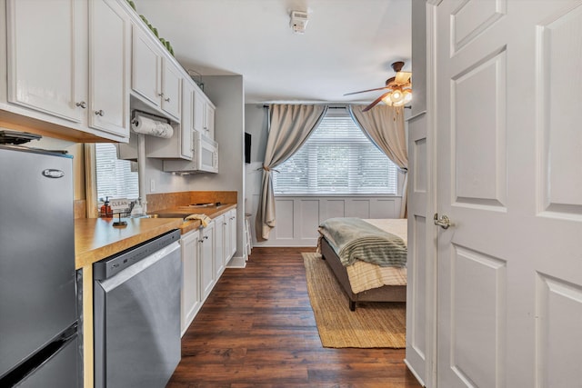 kitchen featuring ceiling fan, white cabinets, stainless steel appliances, and dark wood-type flooring