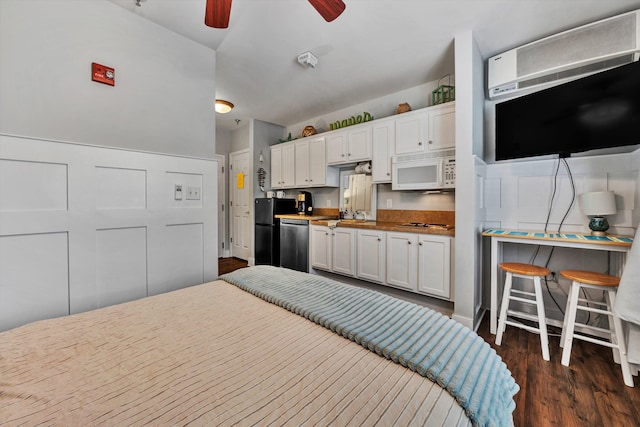 bedroom featuring ceiling fan, stainless steel refrigerator, and dark hardwood / wood-style floors