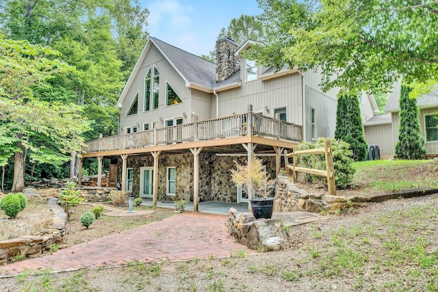 rear view of house featuring a patio, a deck, and central air condition unit