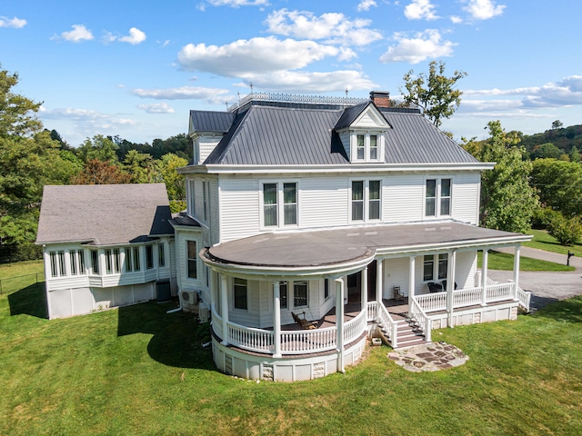 exterior space with a front lawn, covered porch, and central air condition unit