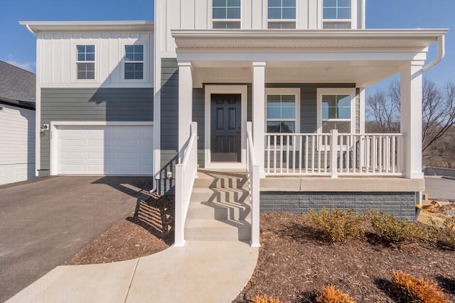 view of front of home featuring a garage and a porch