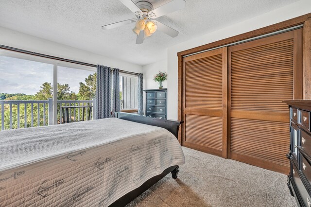 bedroom with carpet, multiple windows, ceiling fan, and a textured ceiling