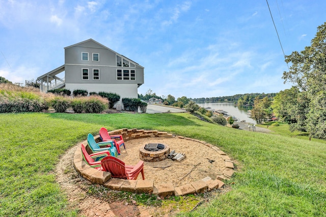 view of yard with a water view and an outdoor fire pit