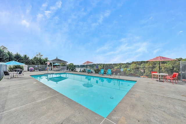 view of swimming pool featuring a patio area and a gazebo