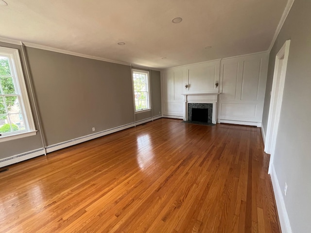 unfurnished living room with crown molding and light hardwood / wood-style flooring