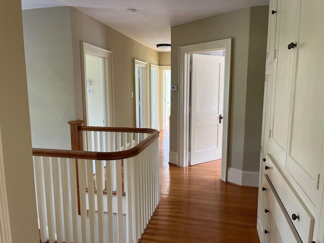 hallway with light hardwood / wood-style floors