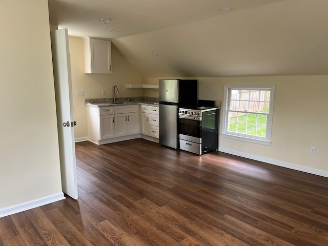 kitchen with white cabinets, lofted ceiling, sink, stainless steel appliances, and dark hardwood / wood-style floors