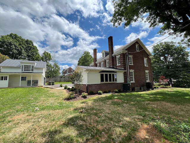 view of side of property with a lawn and a patio area