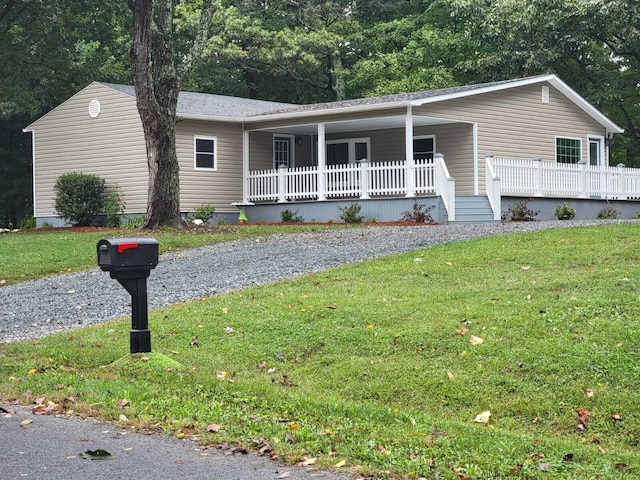 ranch-style house with a porch and a front lawn