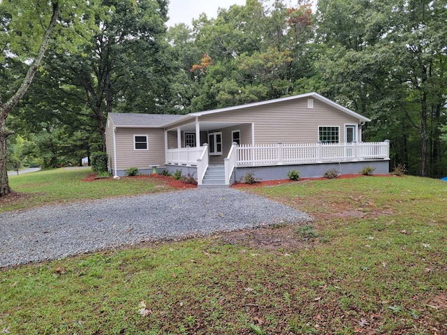 manufactured / mobile home featuring covered porch and a front yard