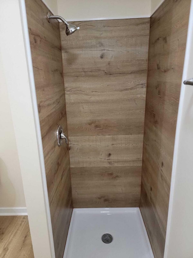 bathroom featuring hardwood / wood-style flooring and a shower