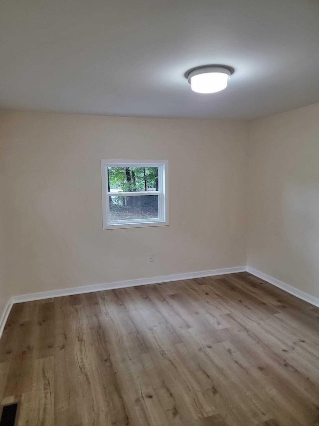 spare room featuring light hardwood / wood-style floors