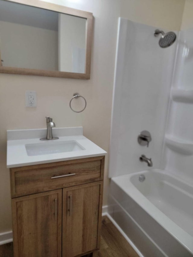 bathroom featuring tub / shower combination, vanity, and wood-type flooring