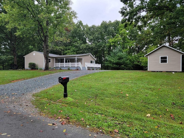 ranch-style home with a storage shed, a front lawn, and a sunroom