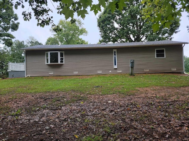 rear view of house featuring a lawn