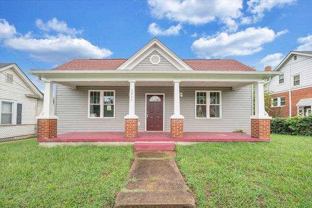 view of front of house featuring covered porch and a front yard