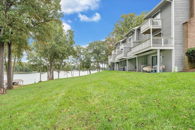 view of yard with a deck with water view