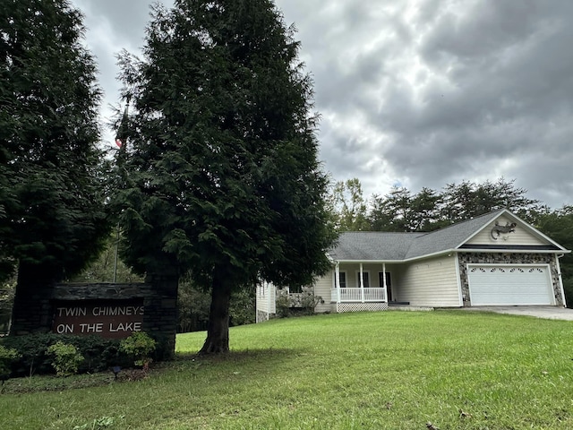 view of front of home with a garage, a porch, and a front lawn