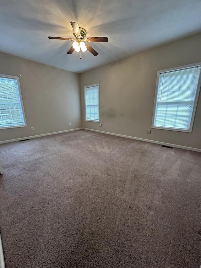 unfurnished room with ceiling fan and carpet flooring