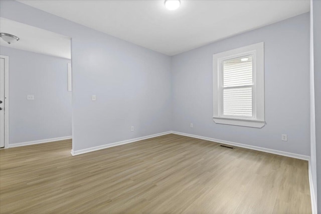 spare room featuring light hardwood / wood-style floors