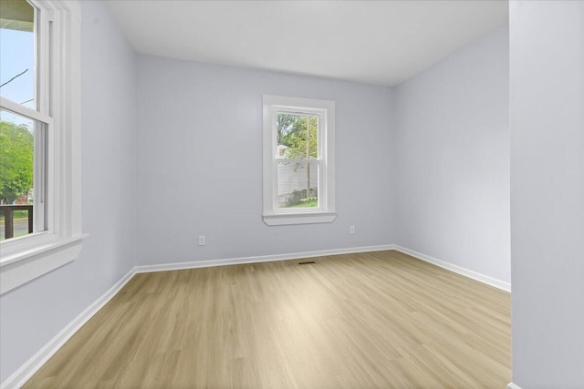 spare room with light wood-type flooring