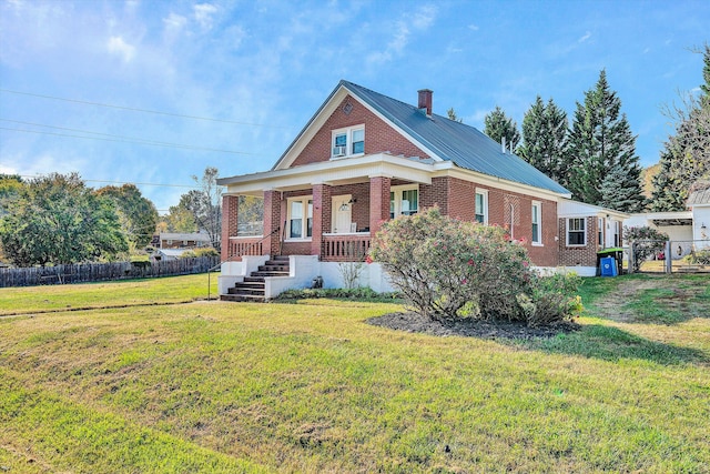 view of front of home featuring a front lawn and covered porch