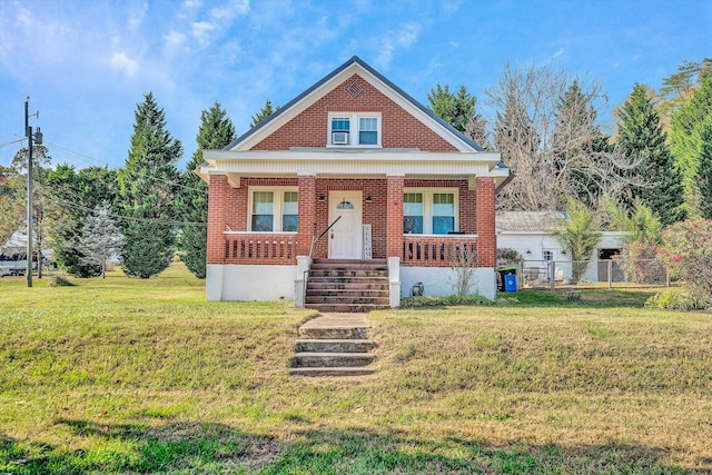 view of front of house with a front yard and covered porch