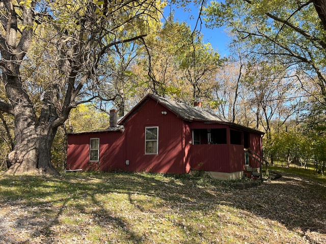 view of outbuilding featuring a yard