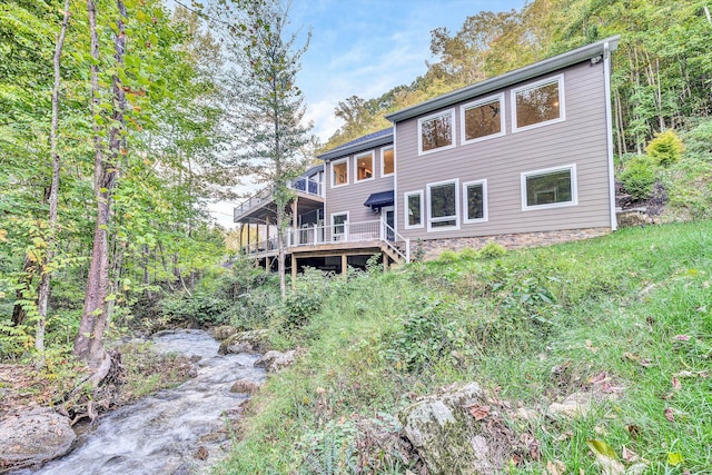 back of property with a wooden deck