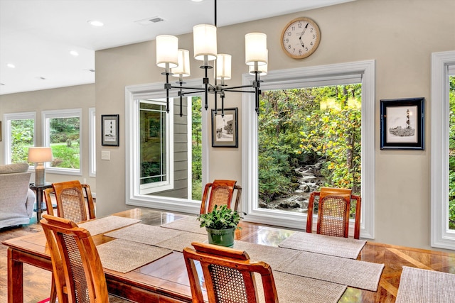 dining area featuring hardwood / wood-style floors and a chandelier