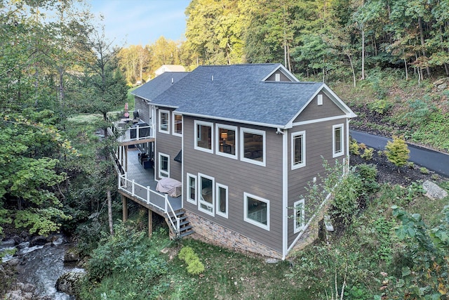 back of property with a wooden deck