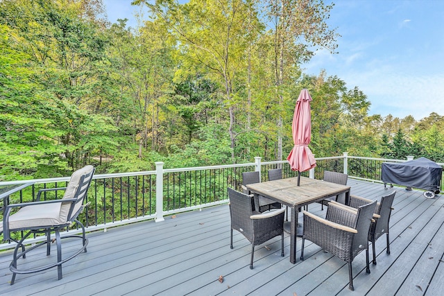 wooden terrace featuring a grill