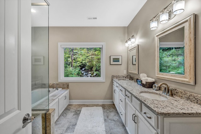 bathroom featuring vanity and a tub