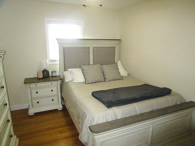 bedroom with dark wood-type flooring