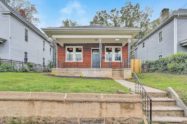 bungalow featuring a front yard and a porch