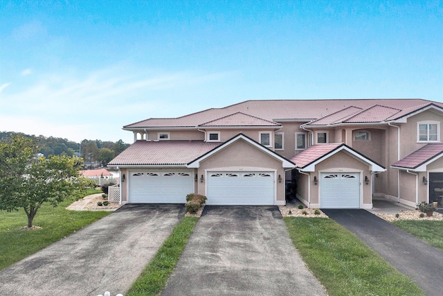 view of front of property featuring a front yard and a garage