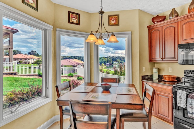 tiled dining area featuring a textured ceiling and a chandelier