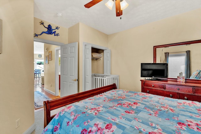 bedroom with ceiling fan, carpet flooring, and multiple windows