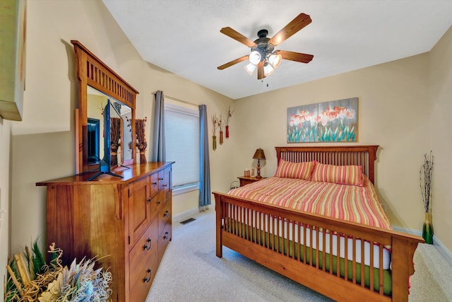 bedroom with light carpet and ceiling fan