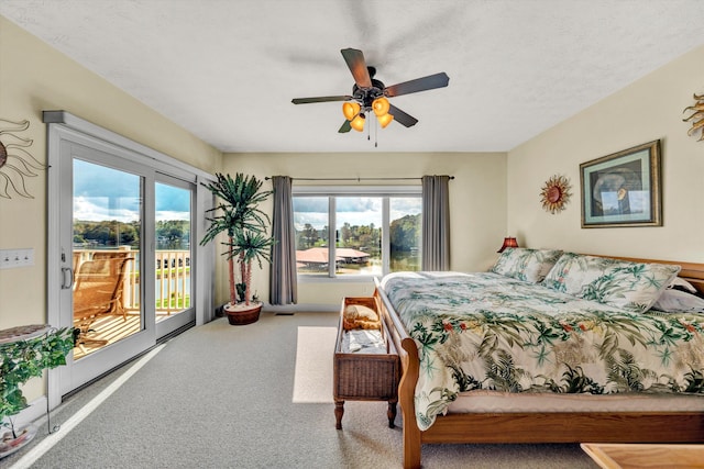 carpeted bedroom featuring ceiling fan, multiple windows, access to outside, and a textured ceiling