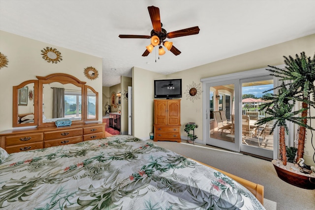 carpeted bedroom with multiple windows, ceiling fan, and access to exterior