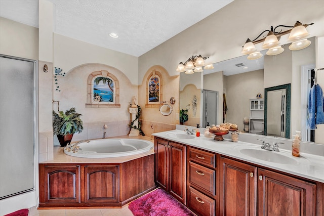 bathroom with vanity, separate shower and tub, a textured ceiling, and tile patterned floors