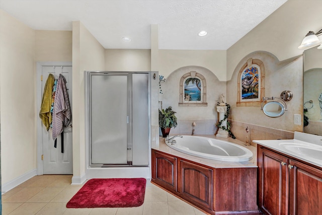 bathroom with vanity, separate shower and tub, a textured ceiling, and tile patterned floors