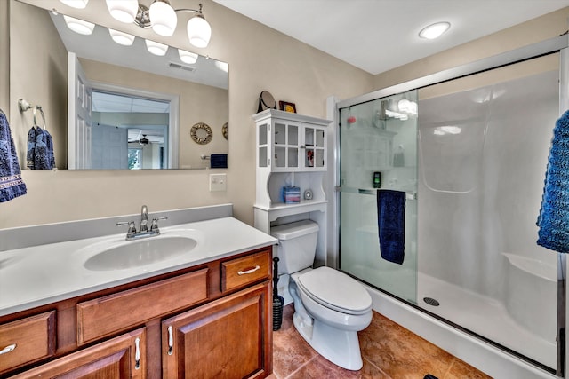 bathroom with tile patterned flooring, a shower with shower door, ceiling fan, vanity, and toilet