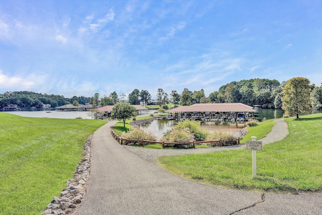 view of property's community featuring a water view and a yard