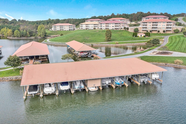 view of dock featuring a lawn and a water view