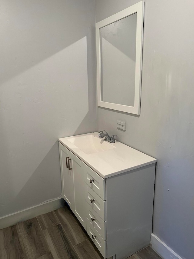 bathroom with hardwood / wood-style floors and vanity